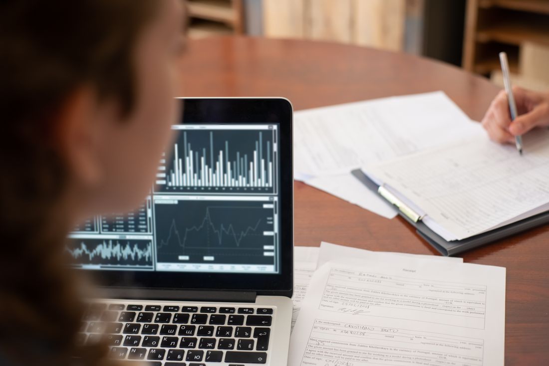 Laptop and documents being reviewed at a meeting.