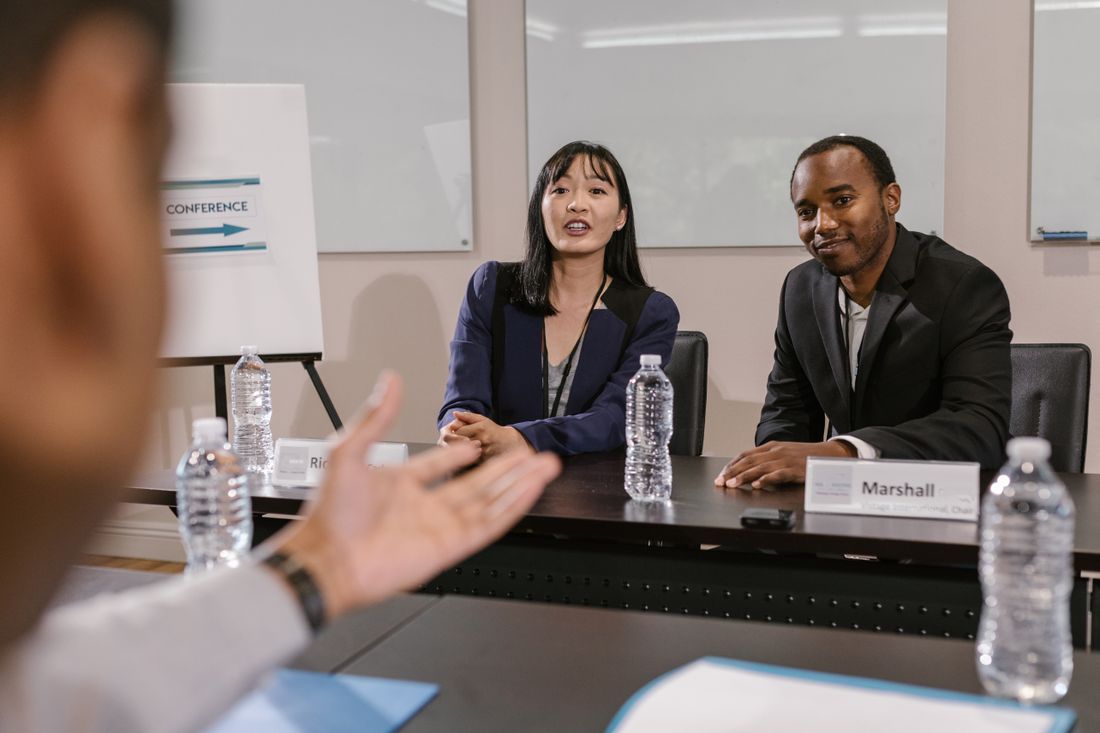 A professional group discussing questions at a meeting.